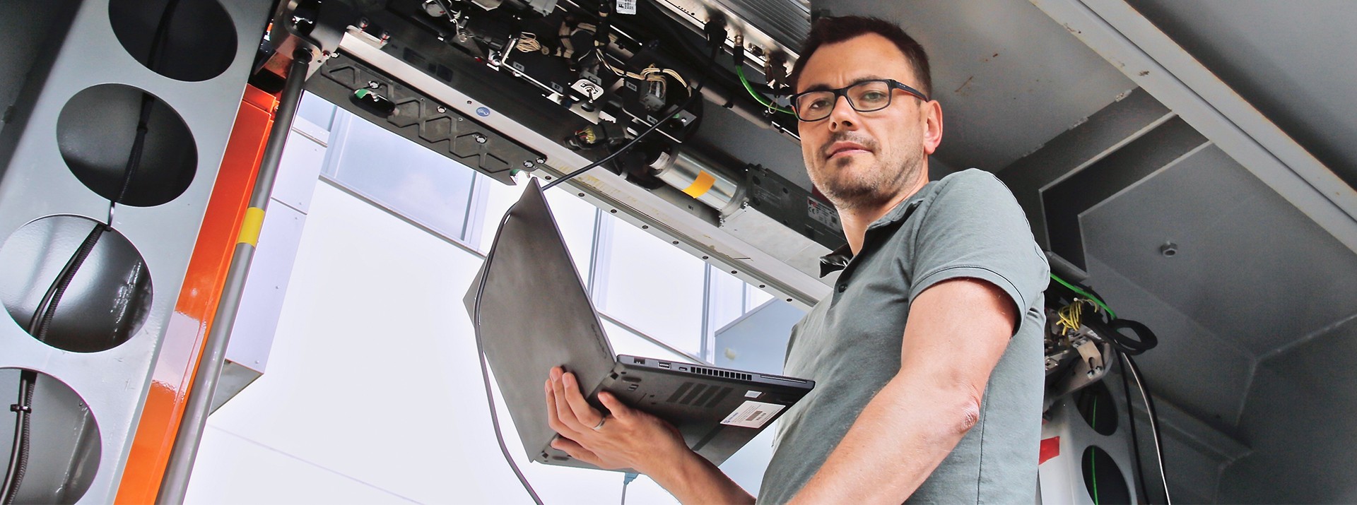 Career Banner - Employee checking the door system with his laptop